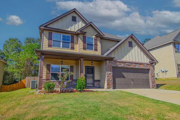 a front view of a house with a yard and garage