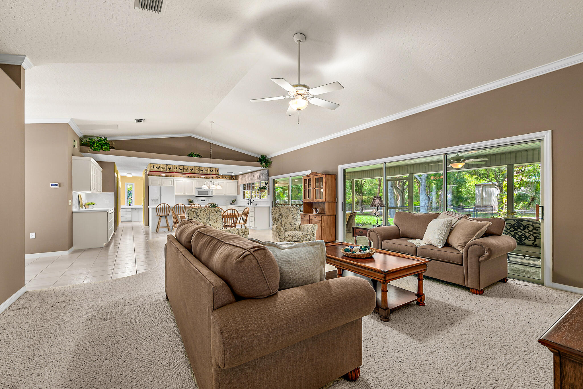 3240 Weber Road Malabar, FL 32950 - Photo 19 of 47 a living room with furniture ceiling fan and a large window