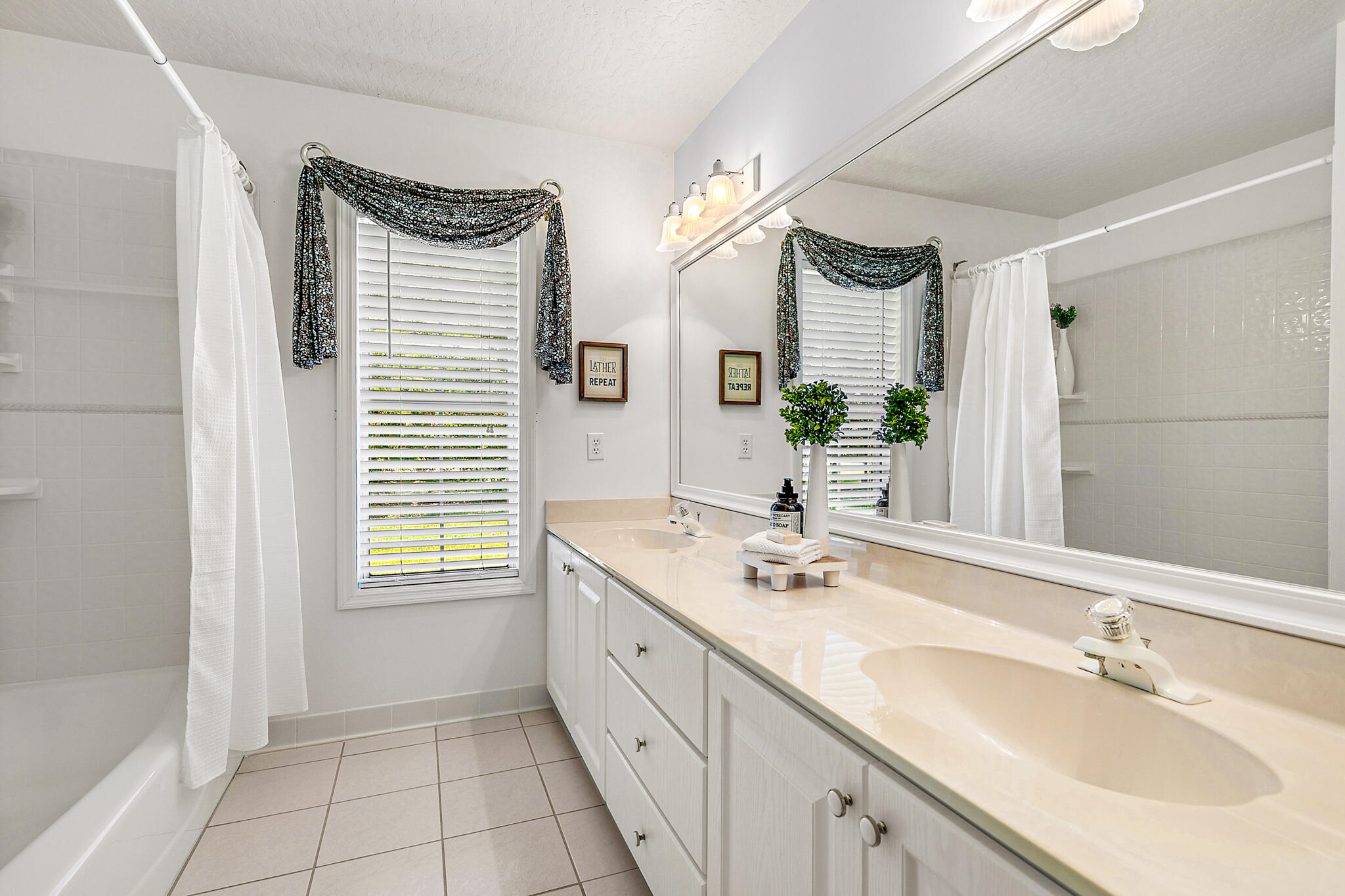 3240 Weber Road Malabar, FL 32950 - Photo 23 of 47 a bathroom with a double vanity sink and a mirror