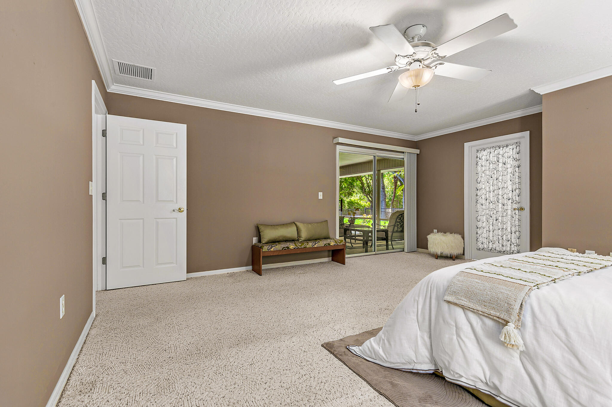 3240 Weber Road Malabar, FL 32950 - Photo 26 of 47 a spacious bedroom with a bed and a chandelier