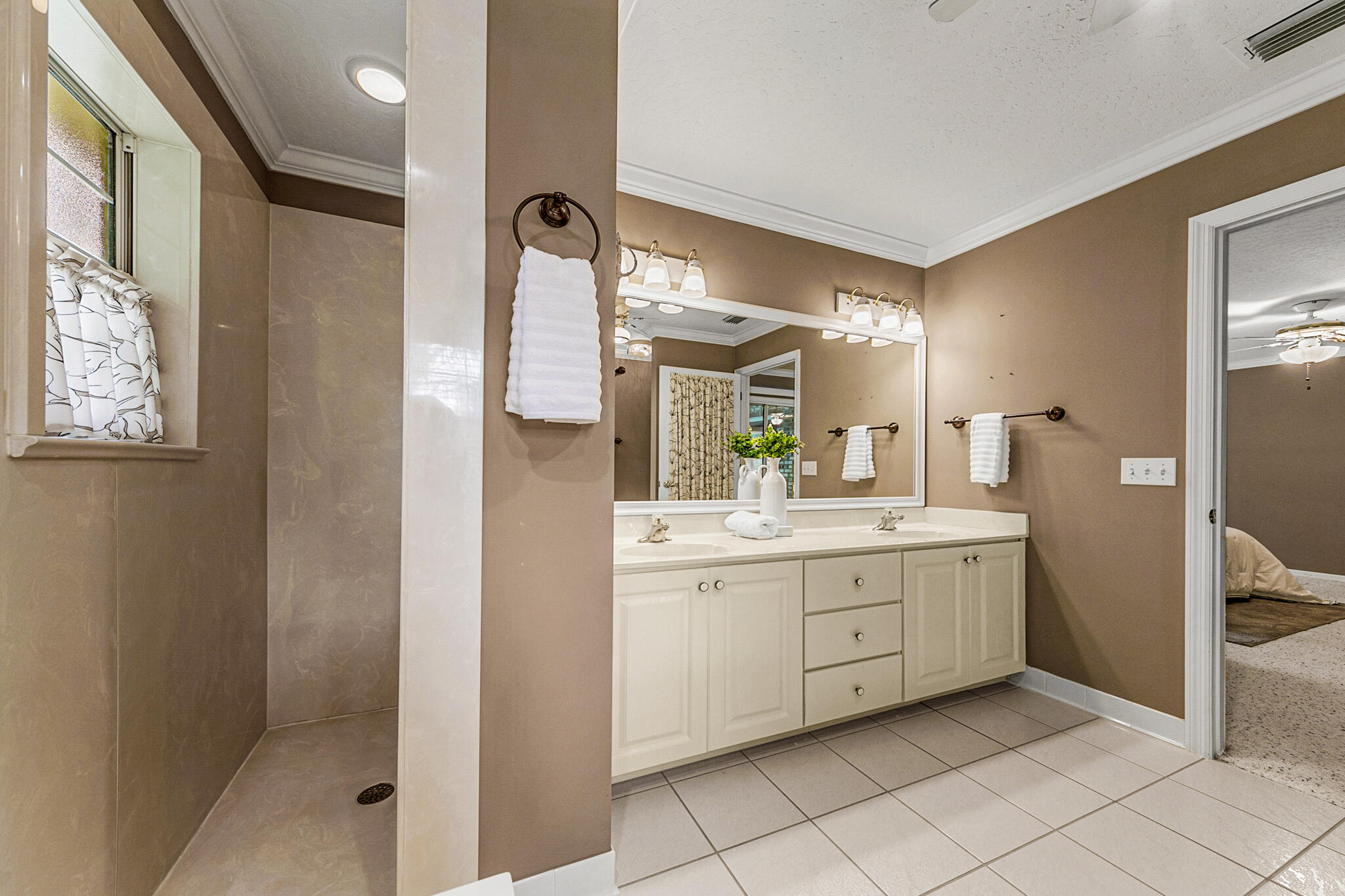 3240 Weber Road Malabar, FL 32950 - Photo 29 of 47 a bathroom with a granite countertop sink a mirror and a shower