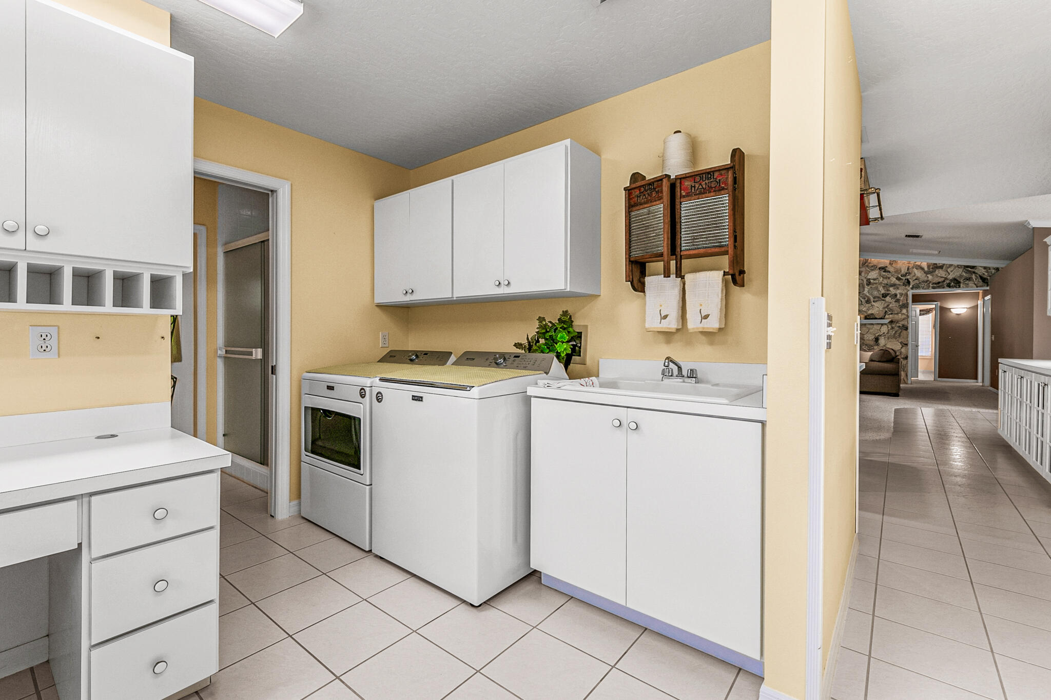 3240 Weber Road Malabar, FL 32950 - Photo 32 of 47 a kitchen with white cabinets and white appliances