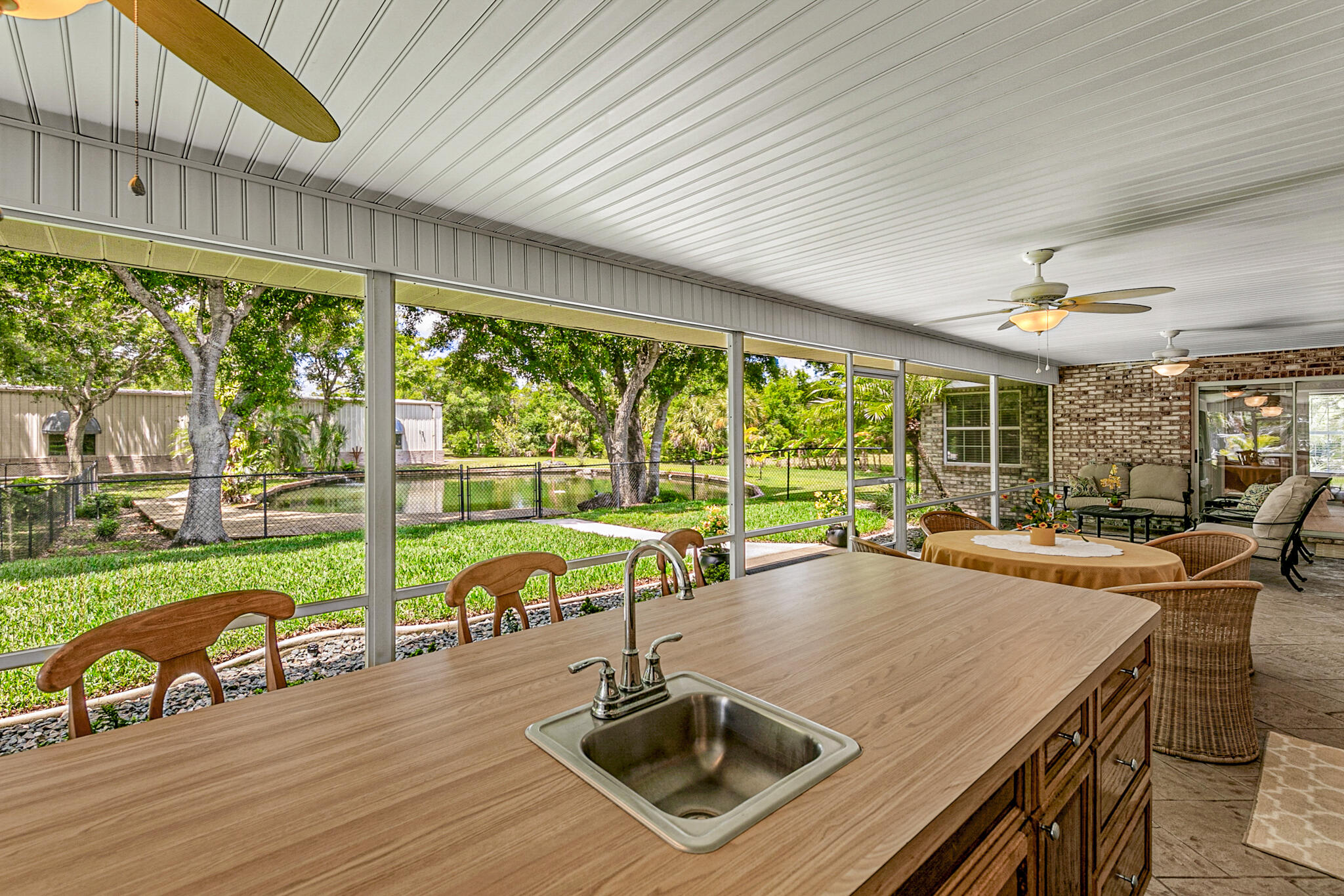 3240 Weber Road Malabar, FL 32950 - Photo 35 of 47 a view of a patio with a table chairs and a patio