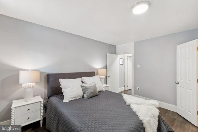 a bedroom with a bed and a lamp