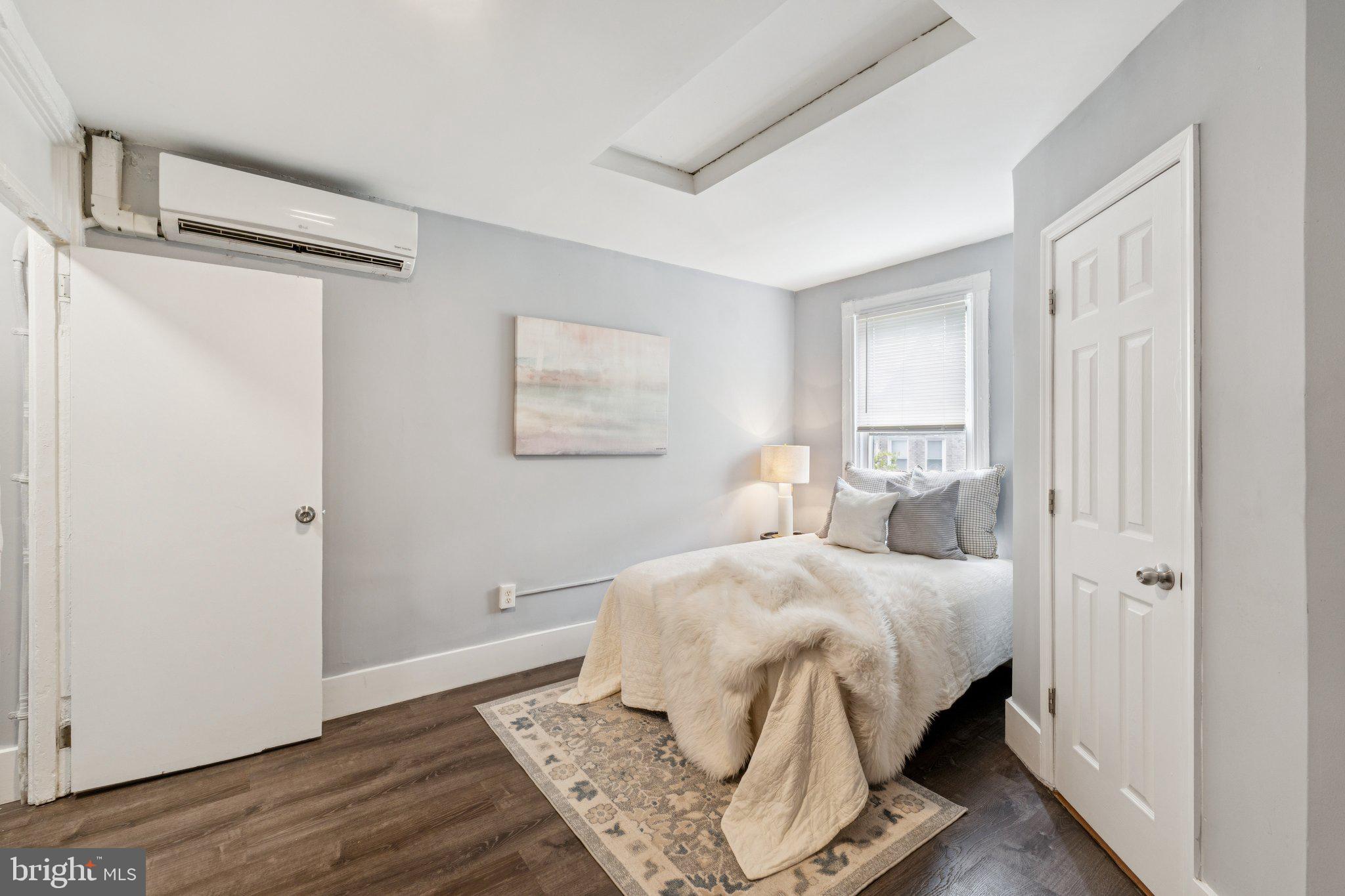 913 Columbia Road Northwest Washington, DC 20001 - Photo 13 of 37 a bedroom with a bed and wooden floor