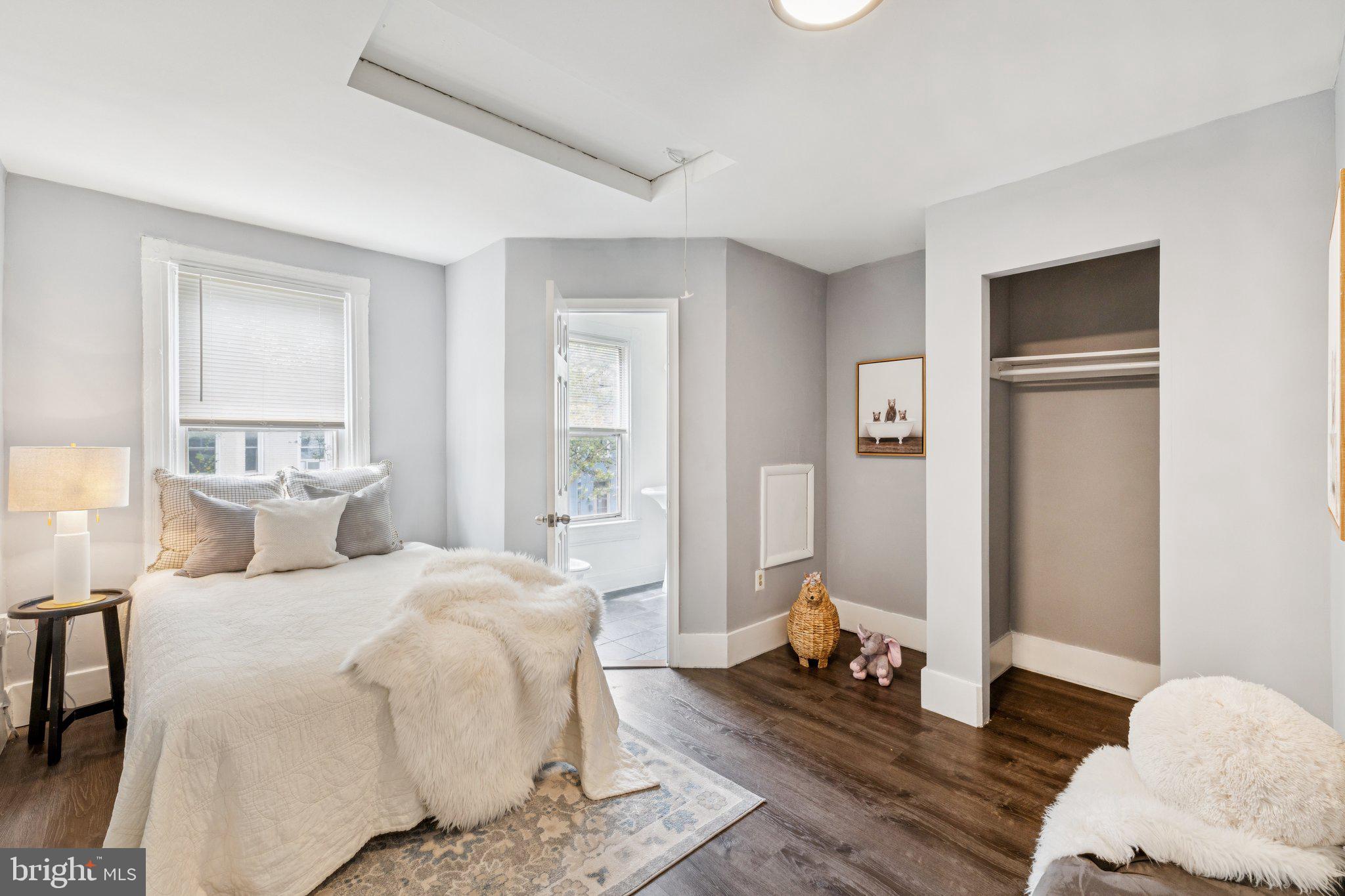 913 Columbia Road Northwest Washington, DC 20001 - Photo 14 of 37 a bedroom with a bed and wooden floor