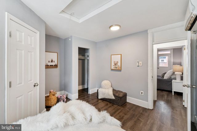 a bedroom with bed and wooden floor