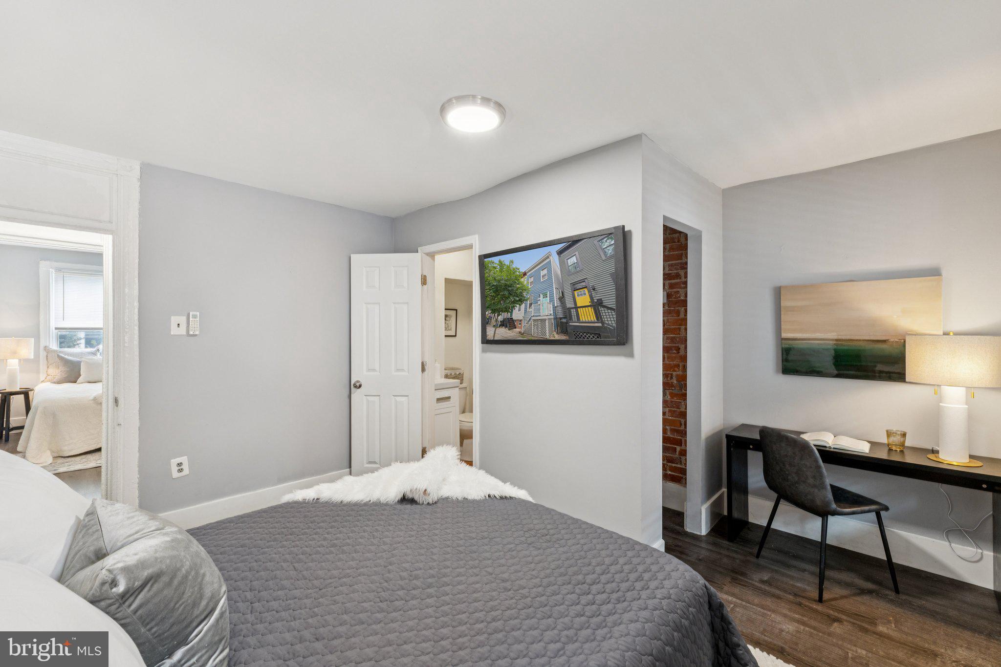 913 Columbia Road Northwest Washington, DC 20001 - Photo 18 of 37 a bedroom with a bed window and a flat screen tv