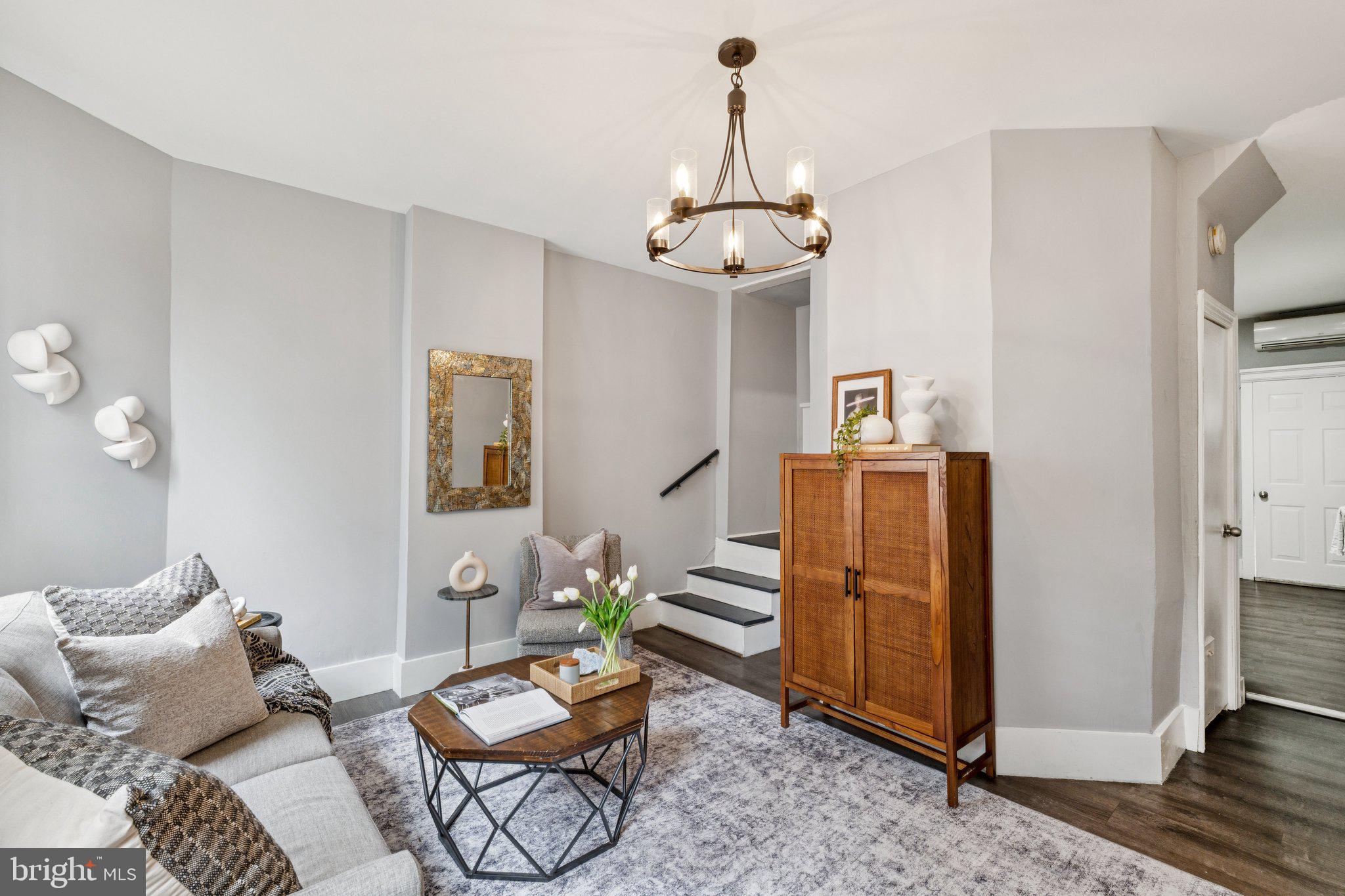 913 Columbia Road Northwest Washington, DC 20001 - Photo 2 of 37 a living room with furniture a rug and a chandelier