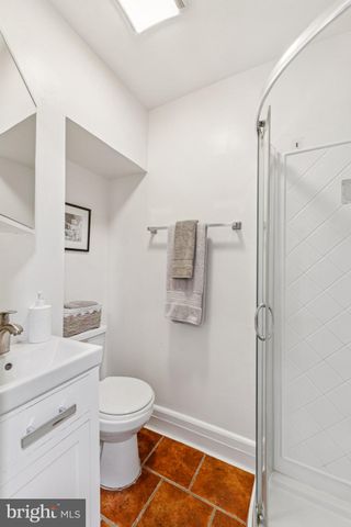 a bathroom with a toilet sink vanity and shower