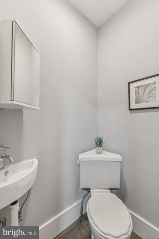 a white toilet sitting next to a bathroom sink
