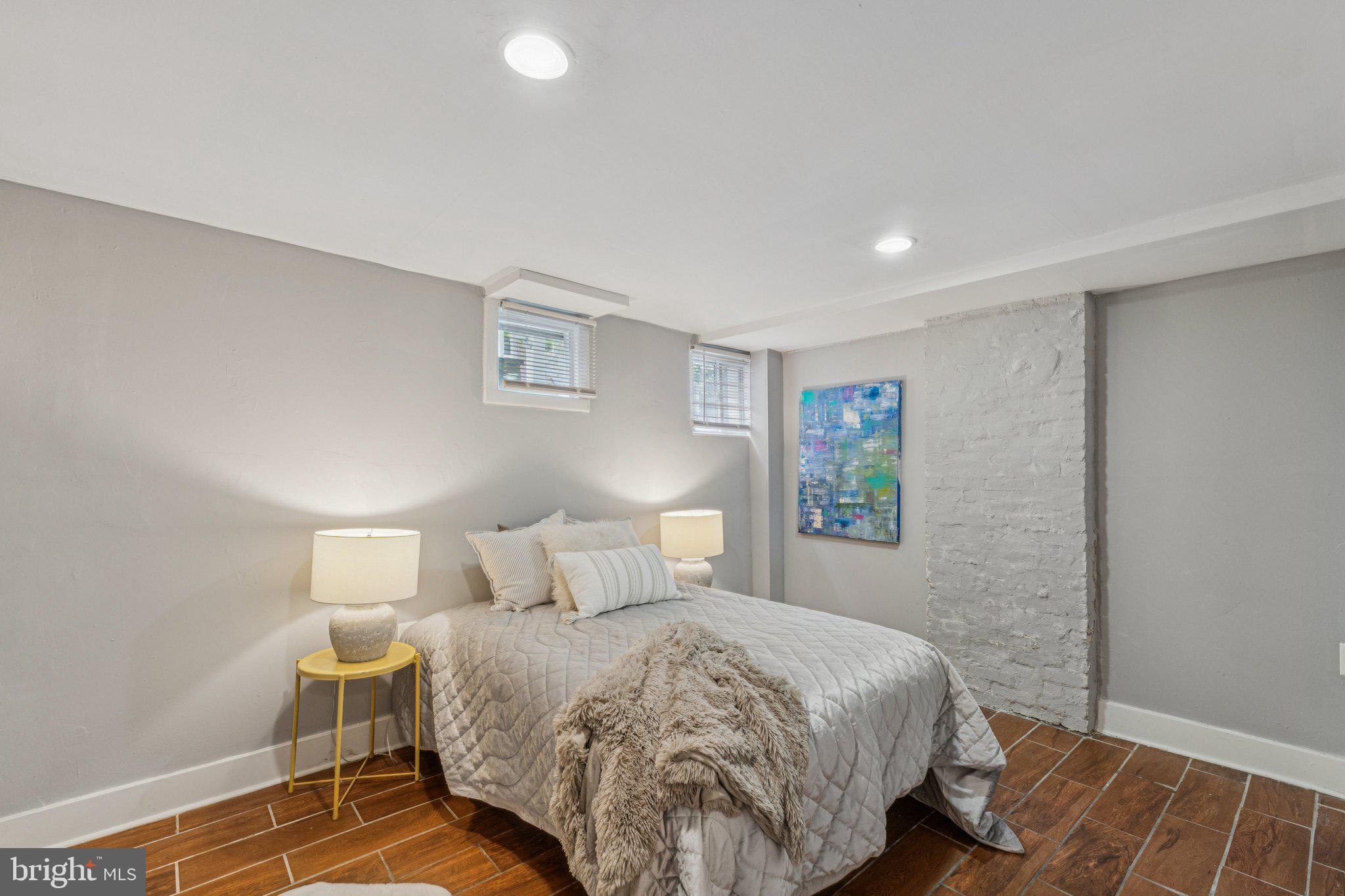 913 Columbia Road Northwest Washington, DC 20001 - Photo 28 of 37 a bedroom with a bed and a lamp