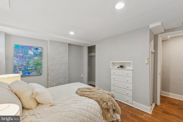 a bedroom with a bed and a dresser