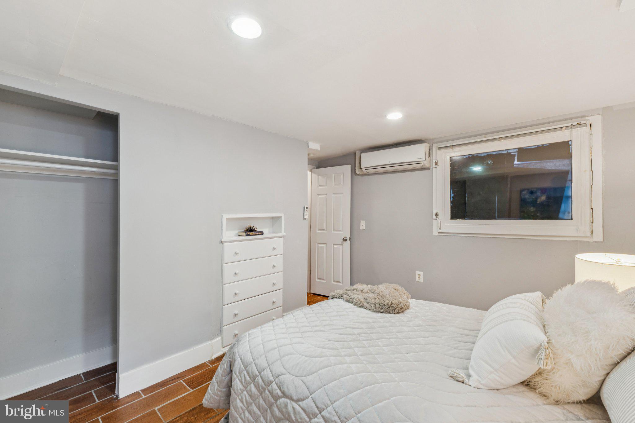 913 Columbia Road Northwest Washington, DC 20001 - Photo 30 of 37 a bedroom with a bed and a mirror
