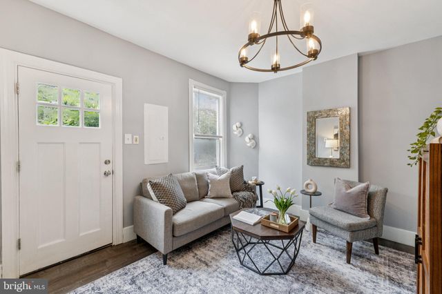 a living room with furniture a rug and a window