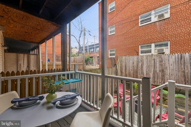 a view of a balcony with chair and wooden floor