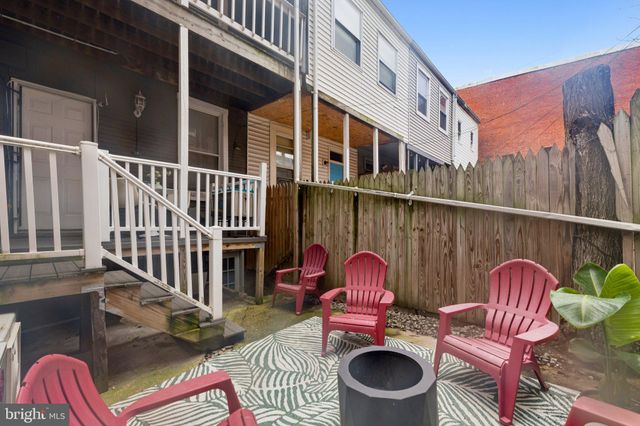 a backyard of a house with outdoor seating