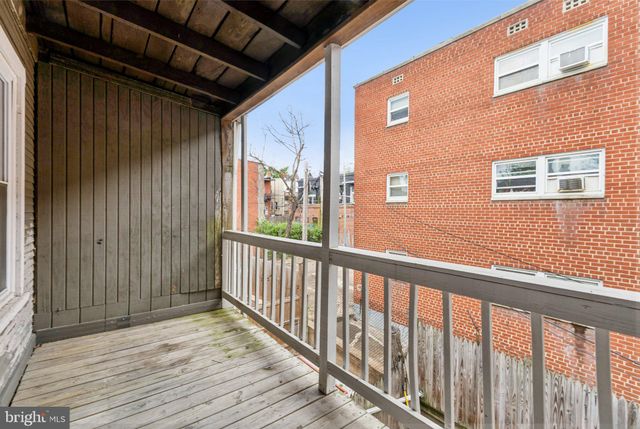 a view of a balcony with wooden floor