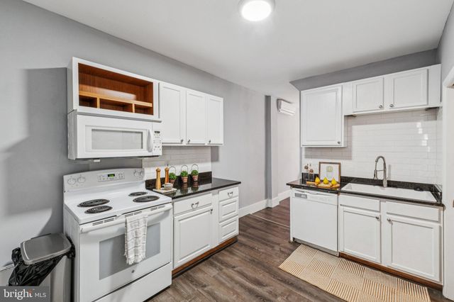 a kitchen with stainless steel appliances a sink stove and cabinets