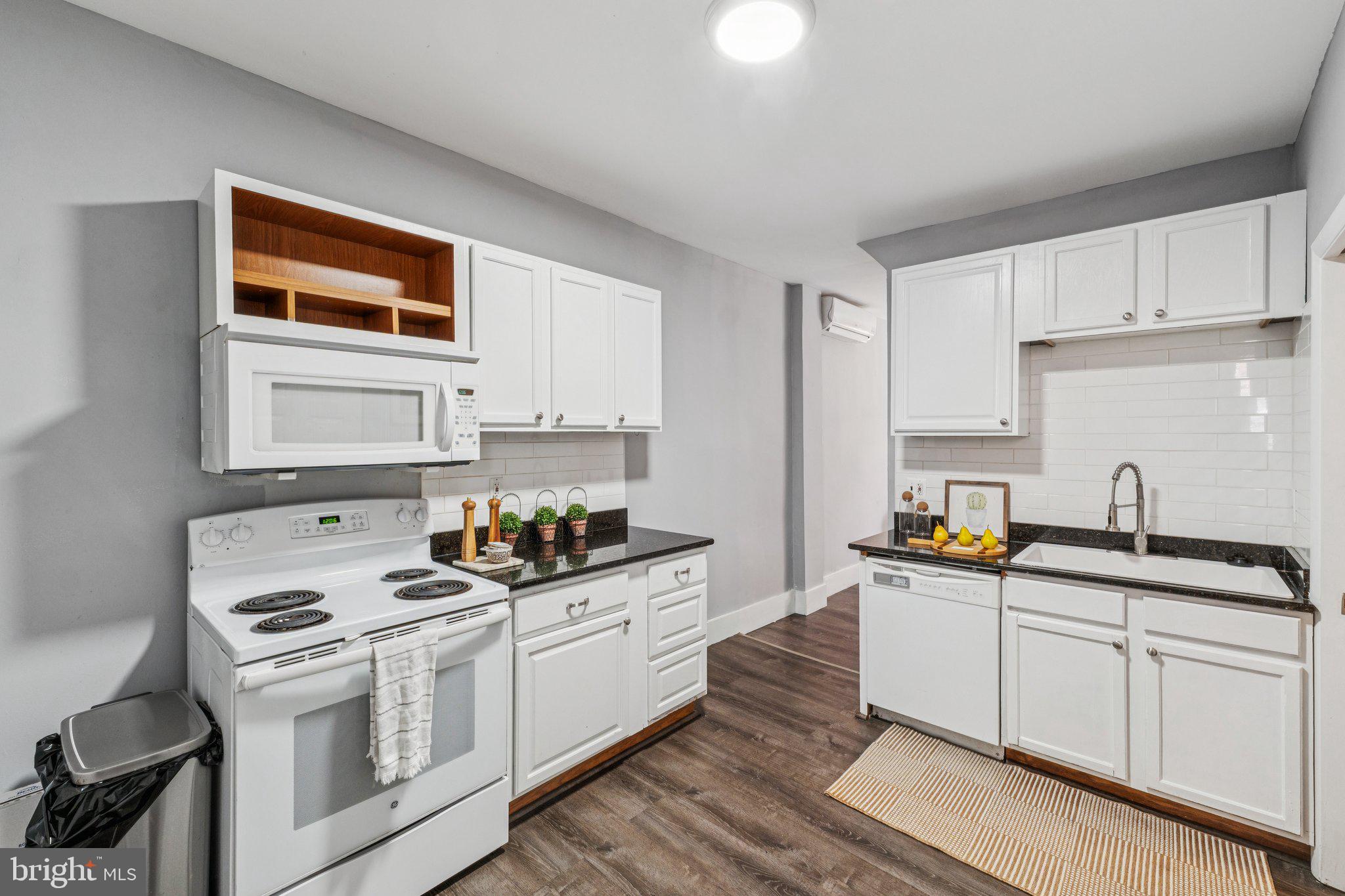 913 Columbia Road Northwest Washington, DC 20001 - Photo 7 of 37 a kitchen with stainless steel appliances a sink stove and cabinets