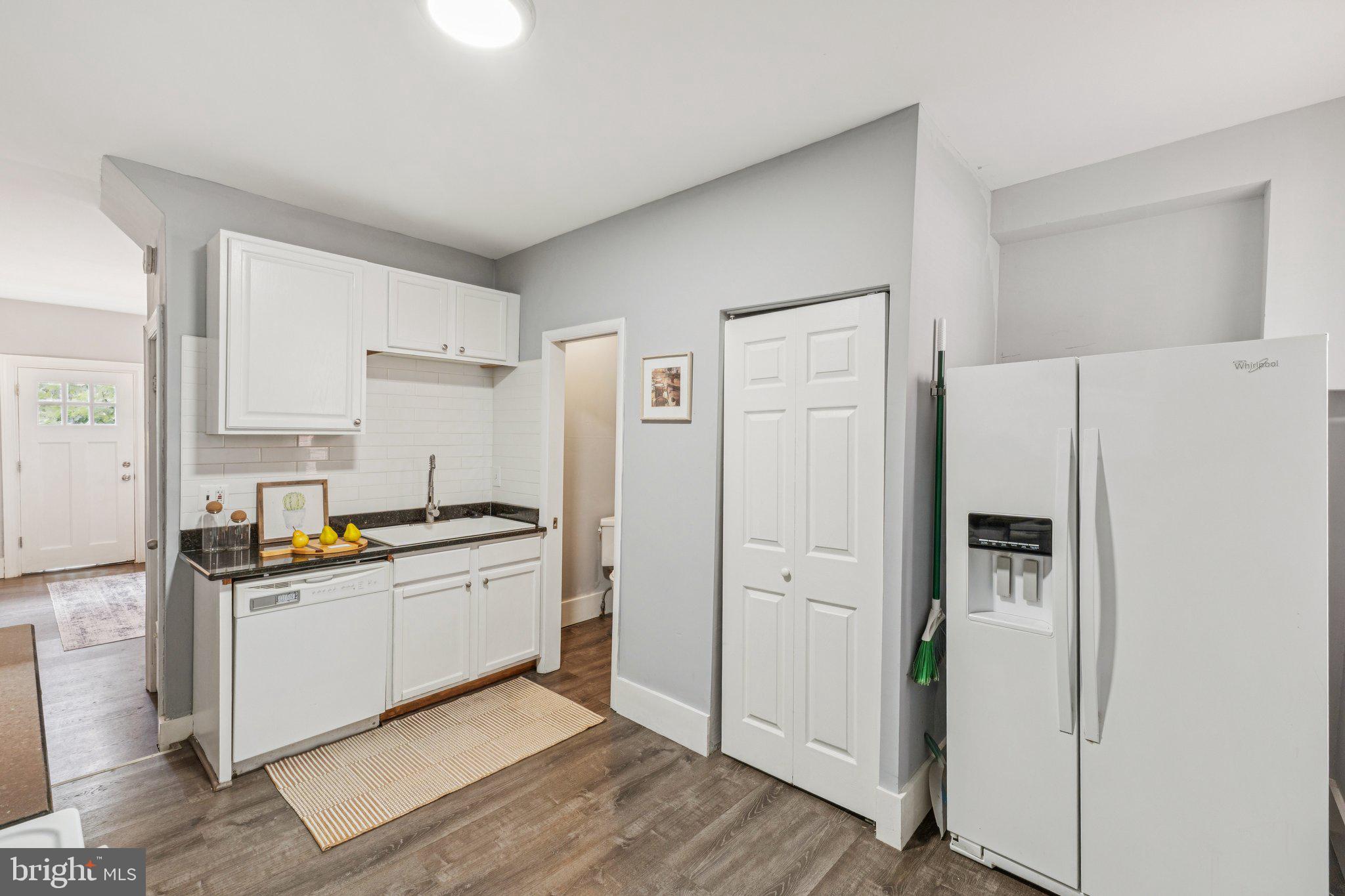 913 Columbia Road Northwest Washington, DC 20001 - Photo 9 of 37 a kitchen with stainless steel appliances a refrigerator a sink and white cabinets
