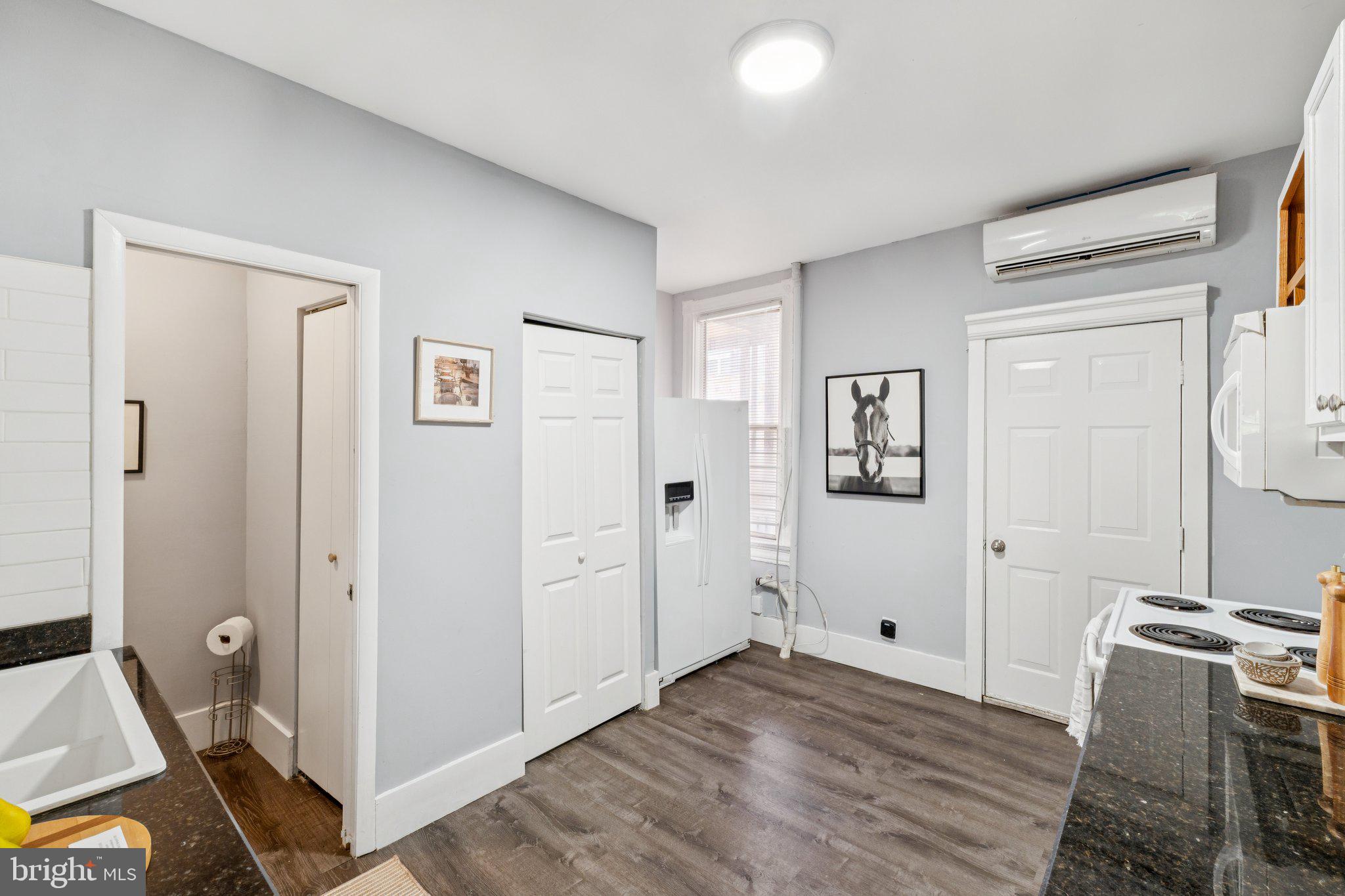 913 Columbia Road Northwest Washington, DC 20001 - Photo 10 of 37 a view of a kitchen with refrigerator and wooden floor