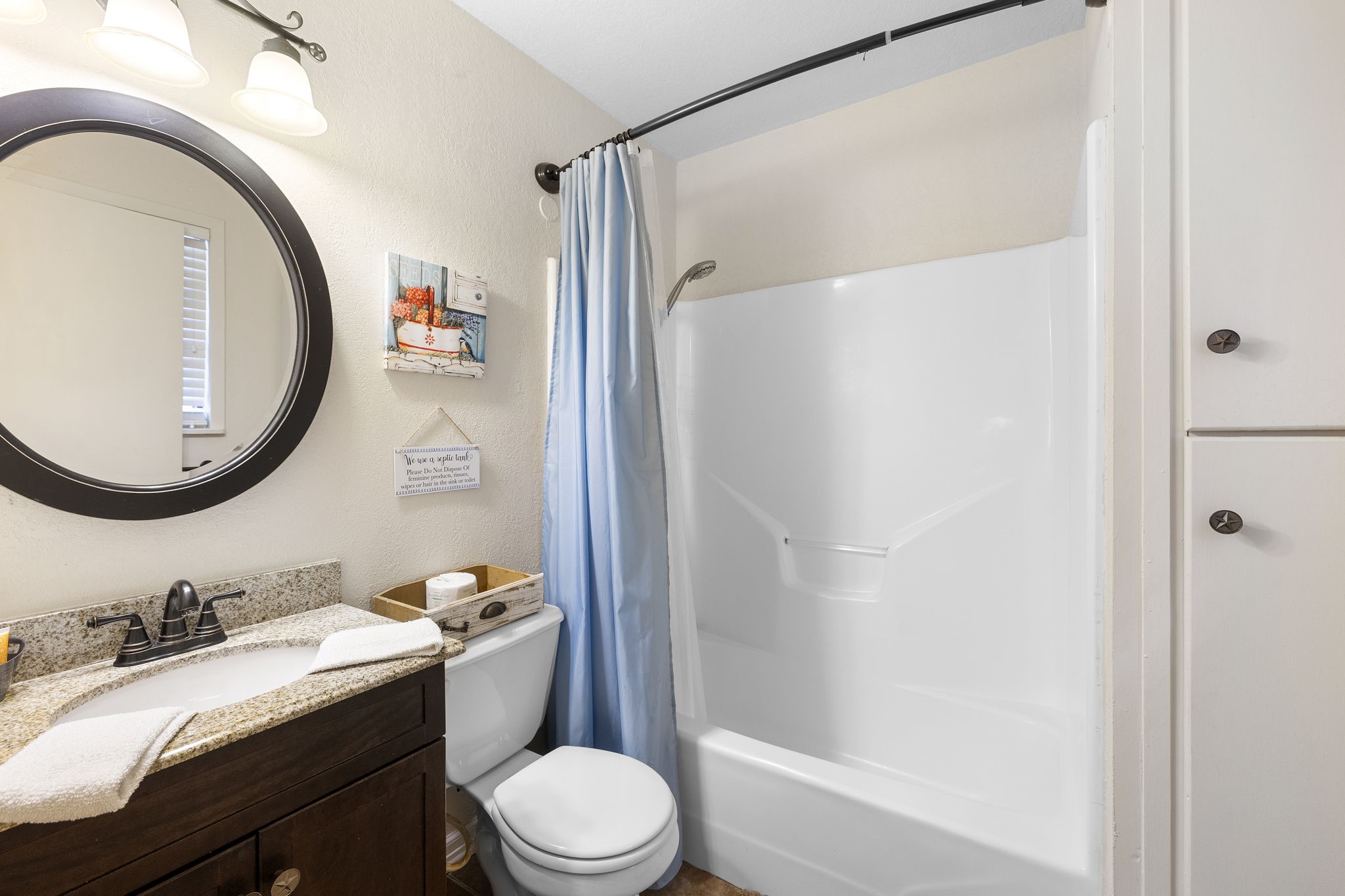 117 Cedar Rdg Lane Concan, TX 78838 - Photo 16 of 38 a bathroom with a granite countertop sink toilet and shower