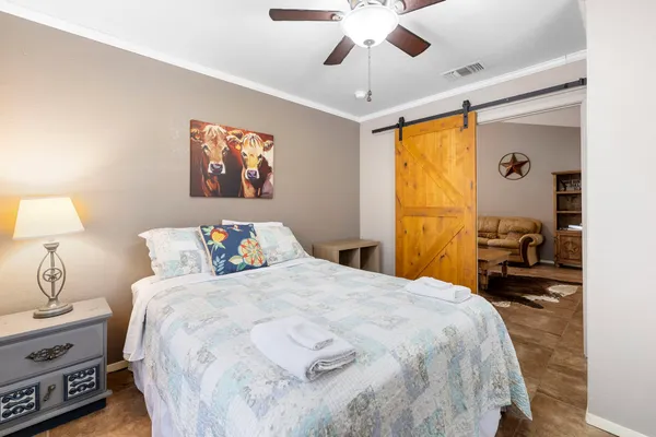 a bedroom with a bed and a chandelier