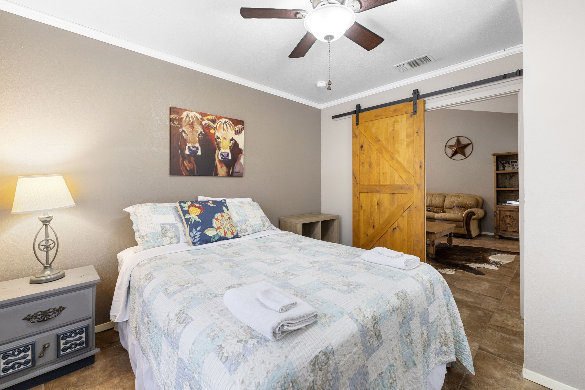 117 Cedar Rdg Lane Concan, TX 78838 - Photo 18 of 38 a bedroom with a bed and a chandelier