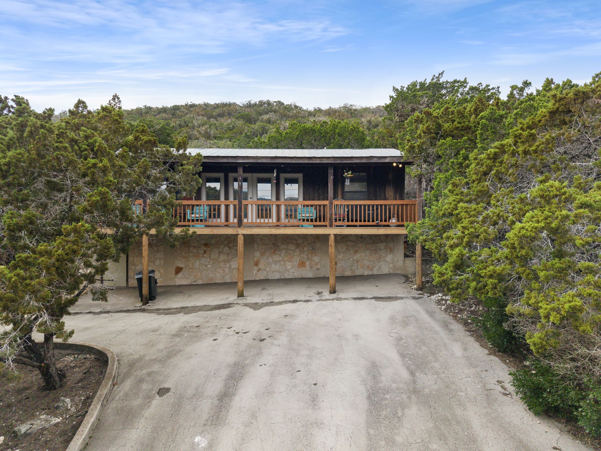 117 Cedar Rdg Lane Concan, TX 78838 - Photo 2 of 38 a view of a house with a yard and potted plants