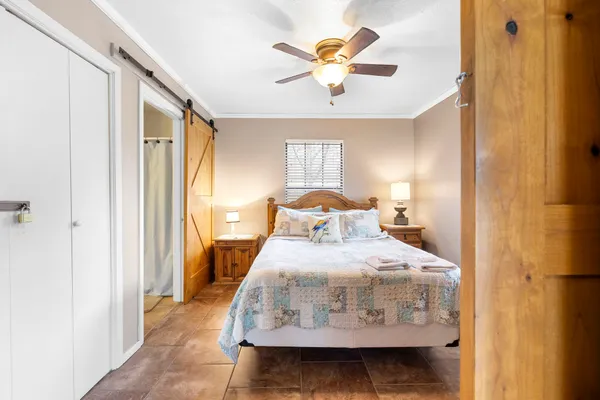 a bedroom with a bed and a chandelier