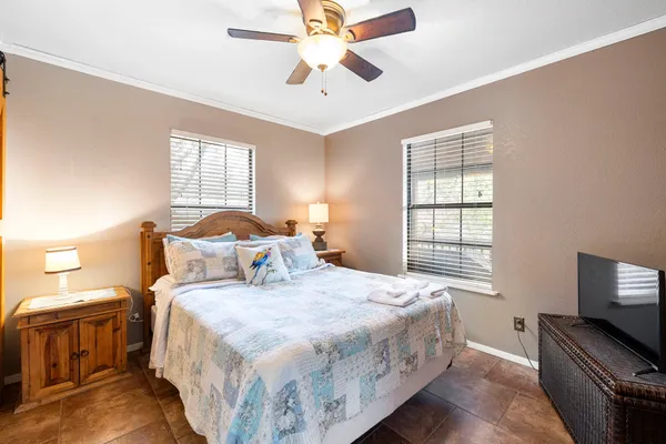 a bedroom with a bed and a flat screen tv