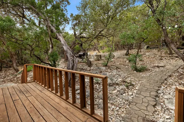a balcony with wooden floor and trees