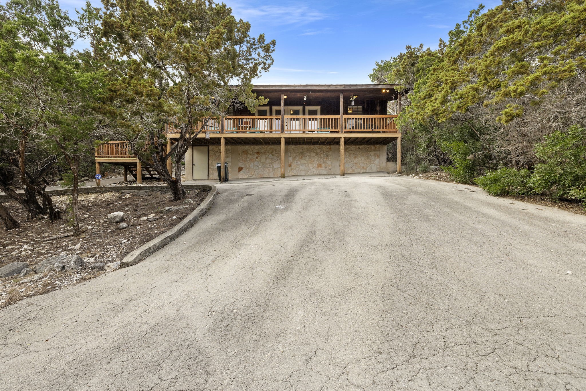 117 Cedar Rdg Lane Concan, TX 78838 - Photo 3 of 38 a view of a house with a yard and large tree