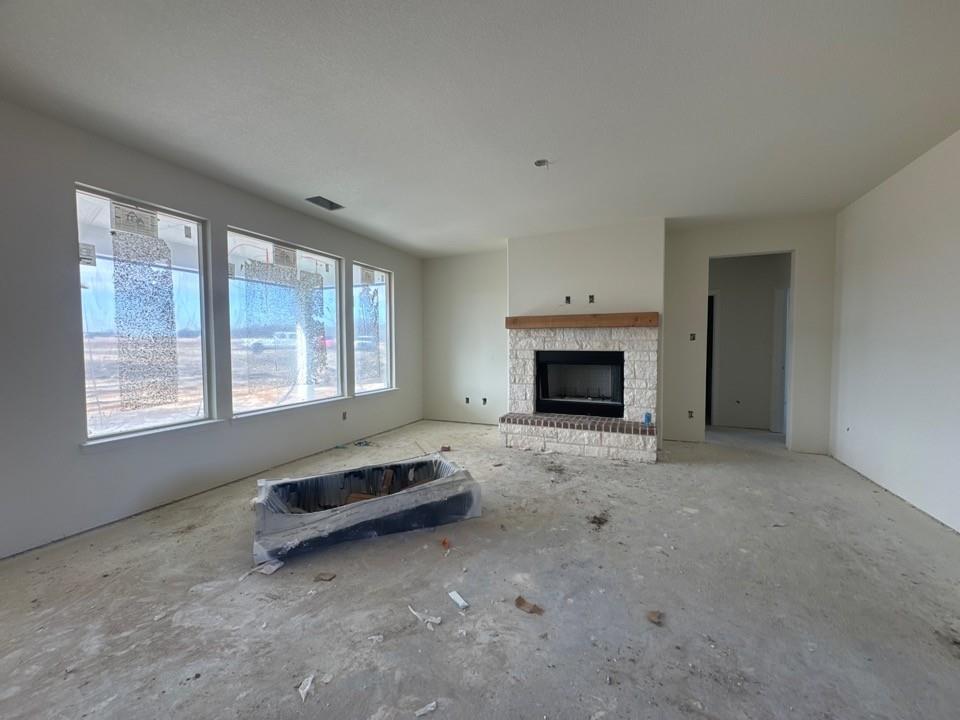 8885 County Road 623 Blue Ridge, TX 75424 - Photo 3 of 11 an empty room with fireplace and window