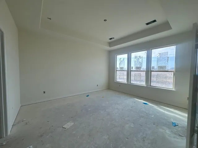 a kitchen with kitchen island a stove a refrigerator a sink a dining table and chairs with wooden floor