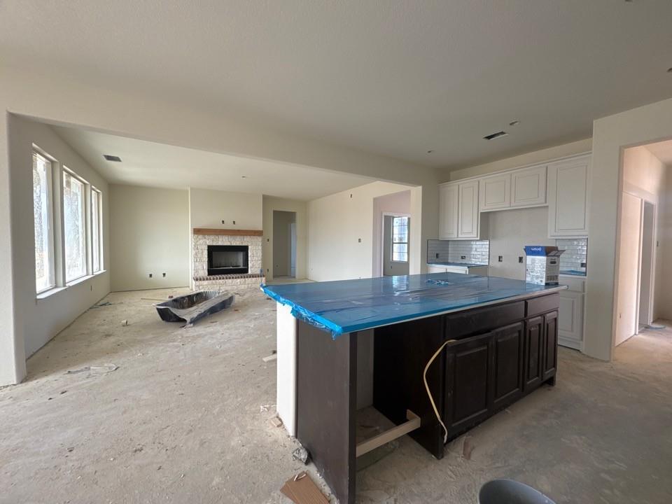 8885 County Road 623 Blue Ridge, TX 75424 - Photo 7 of 11 a kitchen with kitchen island a stove a refrigerator a sink a dining table and chairs with wooden floor