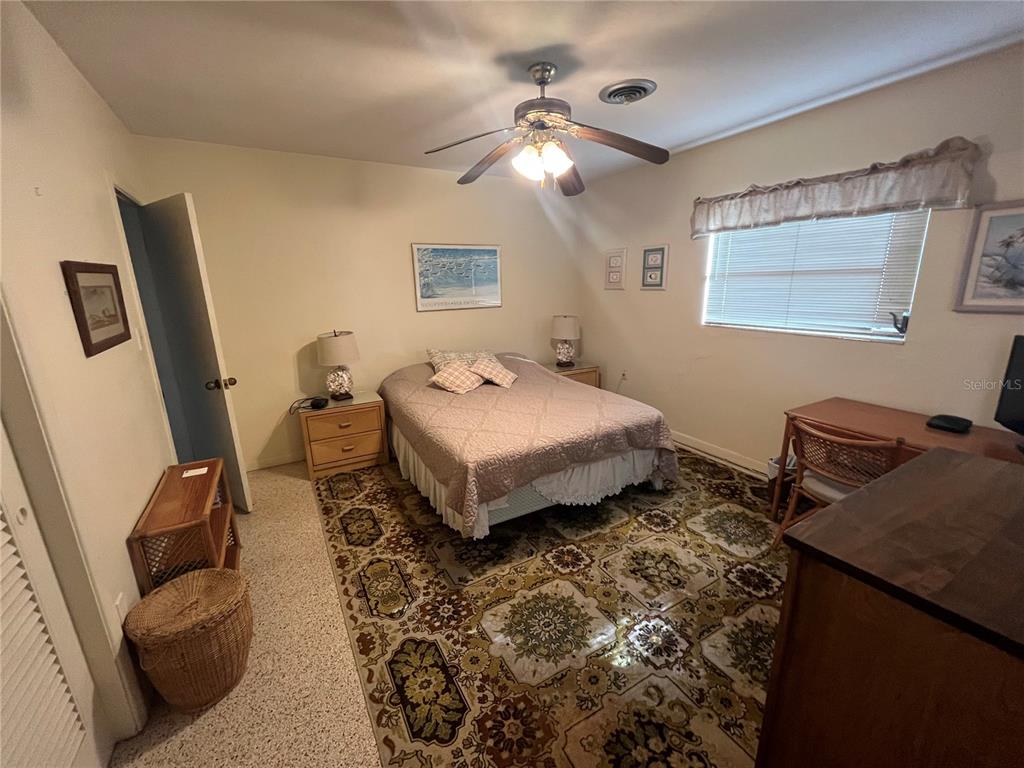 505 Granada Avenue Venice, FL 34285 - Photo 17 of 30 a spacious bedroom with a bed and a chandelier