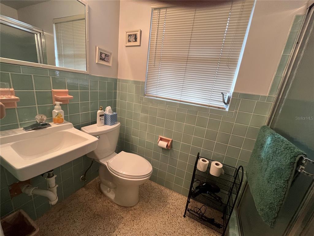 505 Granada Avenue Venice, FL 34285 - Photo 18 of 30 a bathroom with a sink a toilet and a mirror