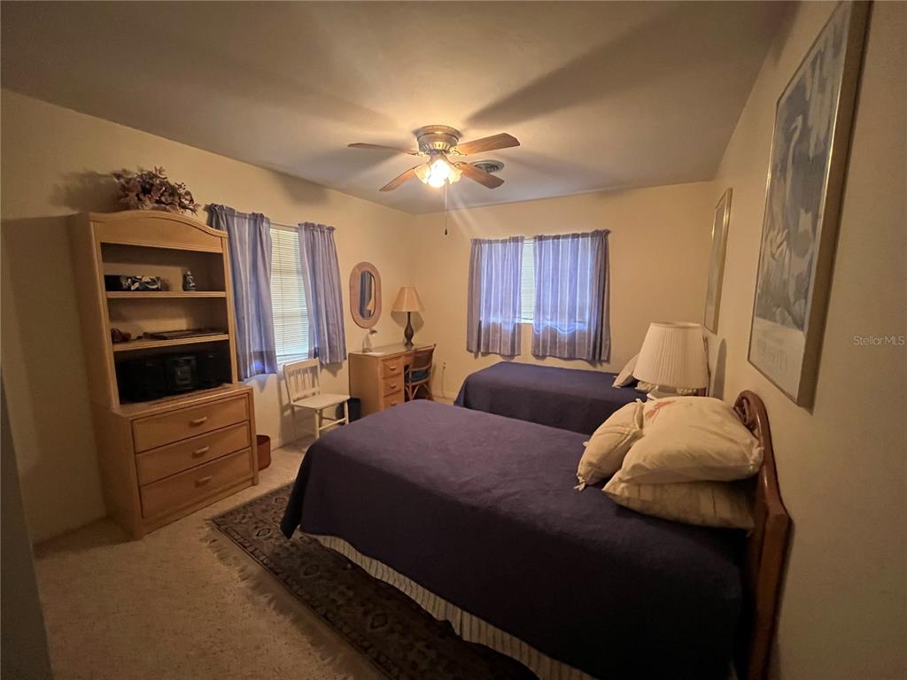 505 Granada Avenue Venice, FL 34285 - Photo 20 of 30 a bedroom with a bed and a chandelier