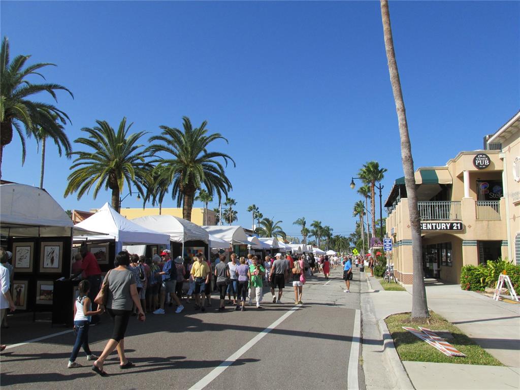 505 Granada Avenue Venice, FL 34285 - Photo 26 of 30 a group of people sitting in a yard in front of retail shops