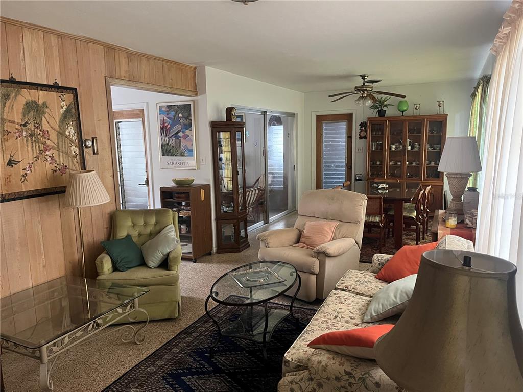 505 Granada Avenue Venice, FL 34285 - Photo 3 of 30 a living room with furniture and a chandelier
