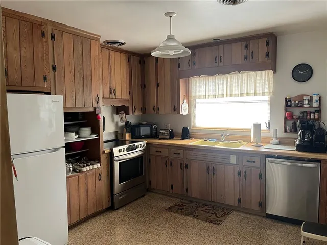 a kitchen with a stove and a refrigerator