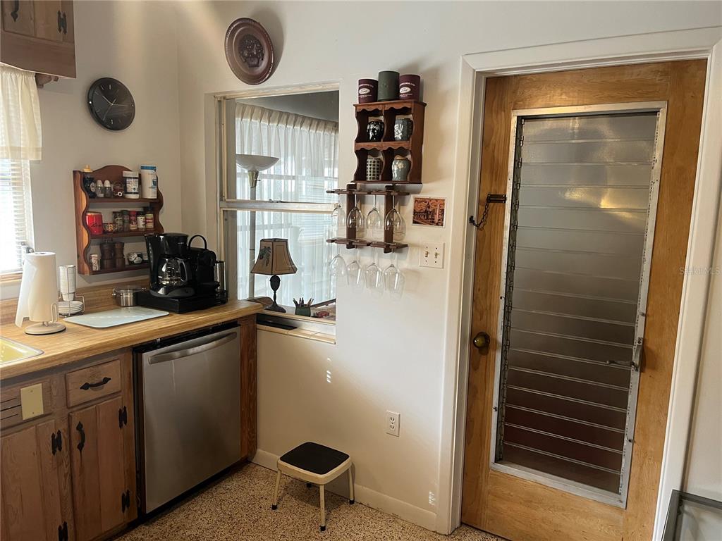505 Granada Avenue Venice, FL 34285 - Photo 8 of 30 a kitchen with a refrigerator and a sink