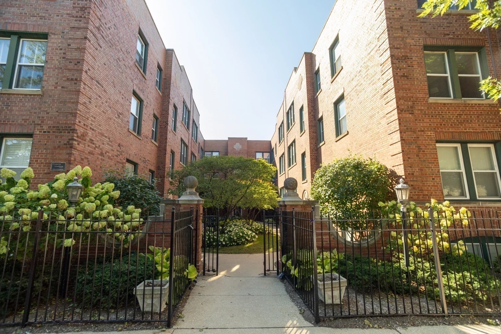 a view of a brick building next to a yard