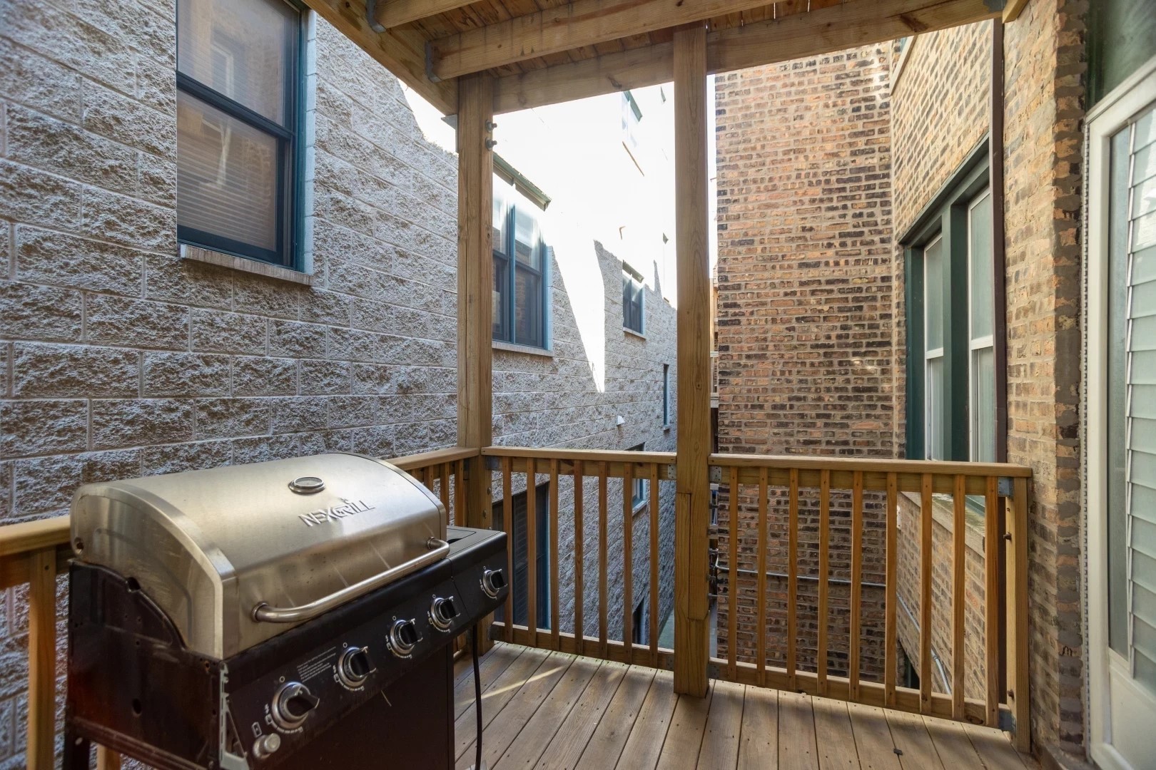 2026 North Burling Street, Unit 208 Chicago, IL 60614 - Photo 12 of 14 a view of a balcony with furniture and a window