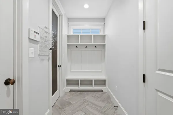 a view of a hallway with wooden shelves