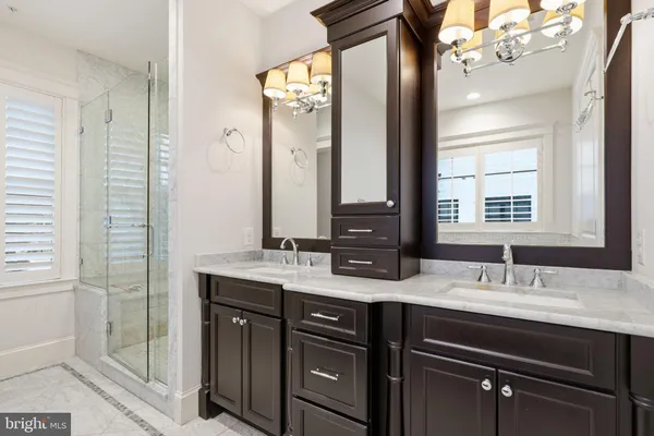 a bathroom with a double vanity sink and mirror
