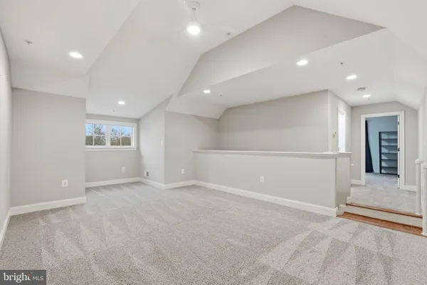 an empty room with entrance and windows