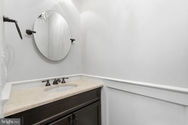a bathroom with a sink vanity and a mirror